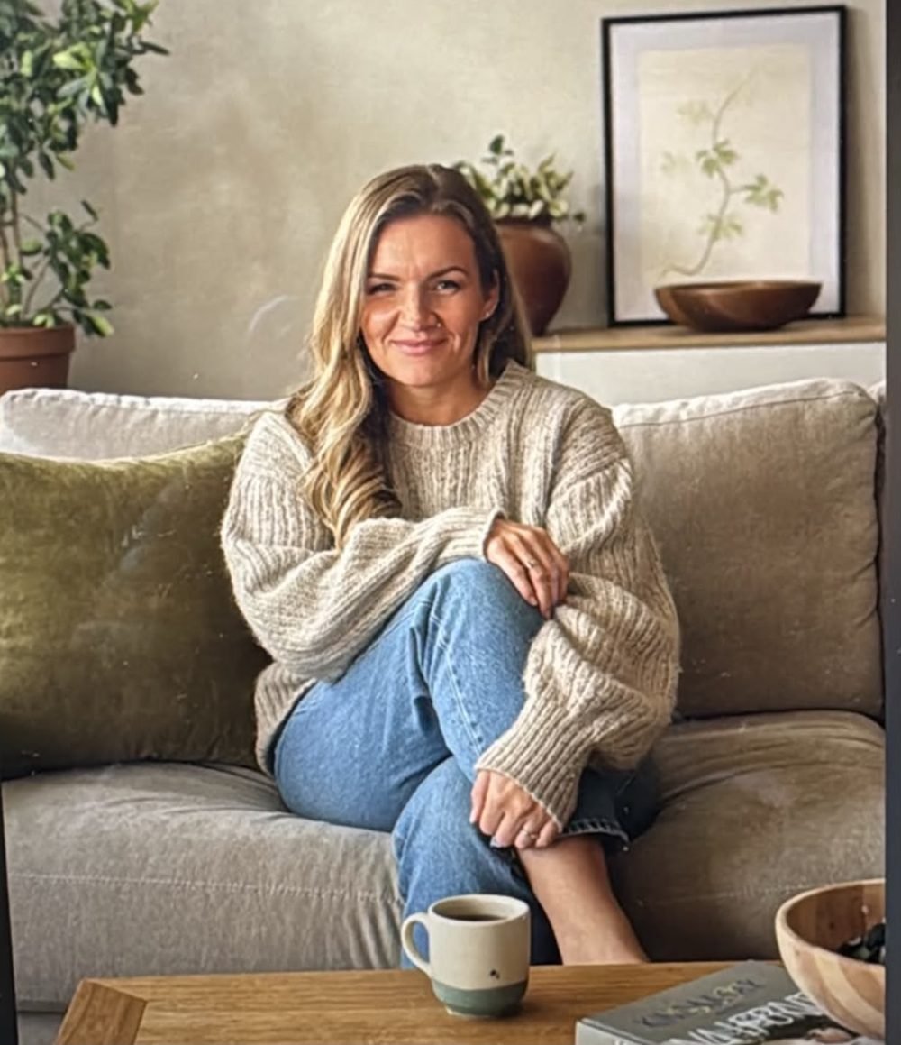 Deb sitting on a sofa with a cup of tea